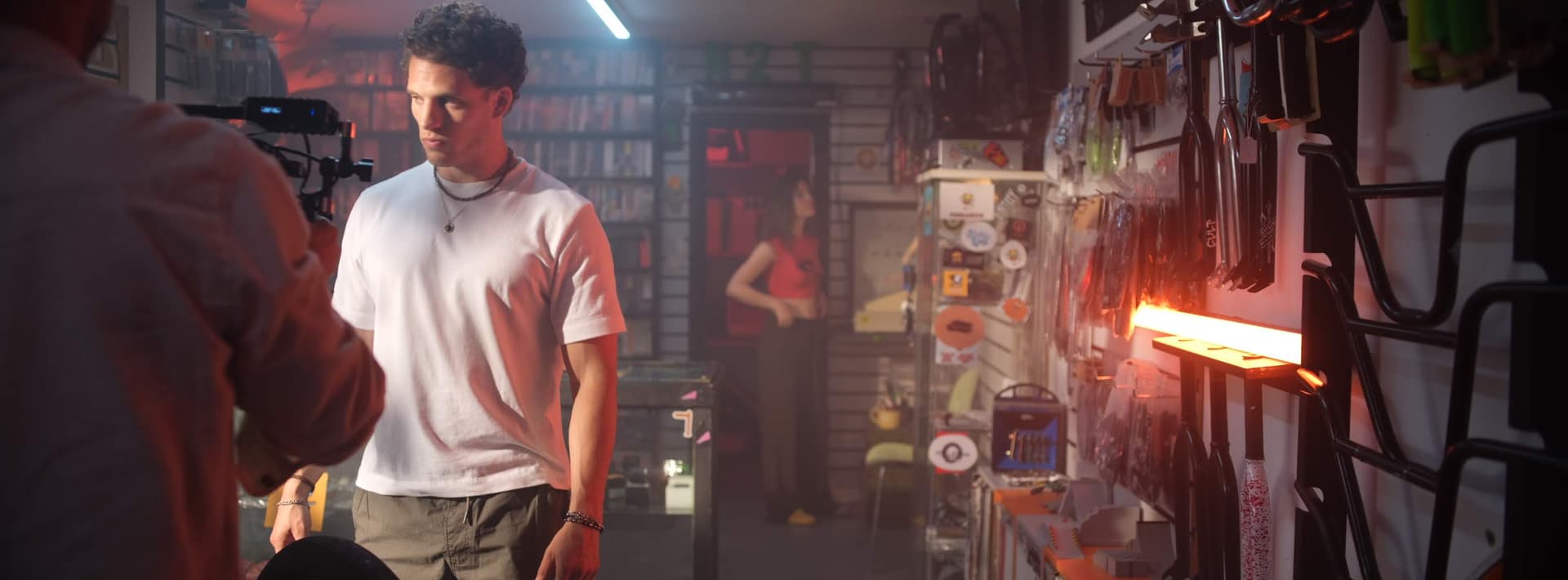 Behind the scenes - Tristan Alexander on a neon-lit garage set being filmed