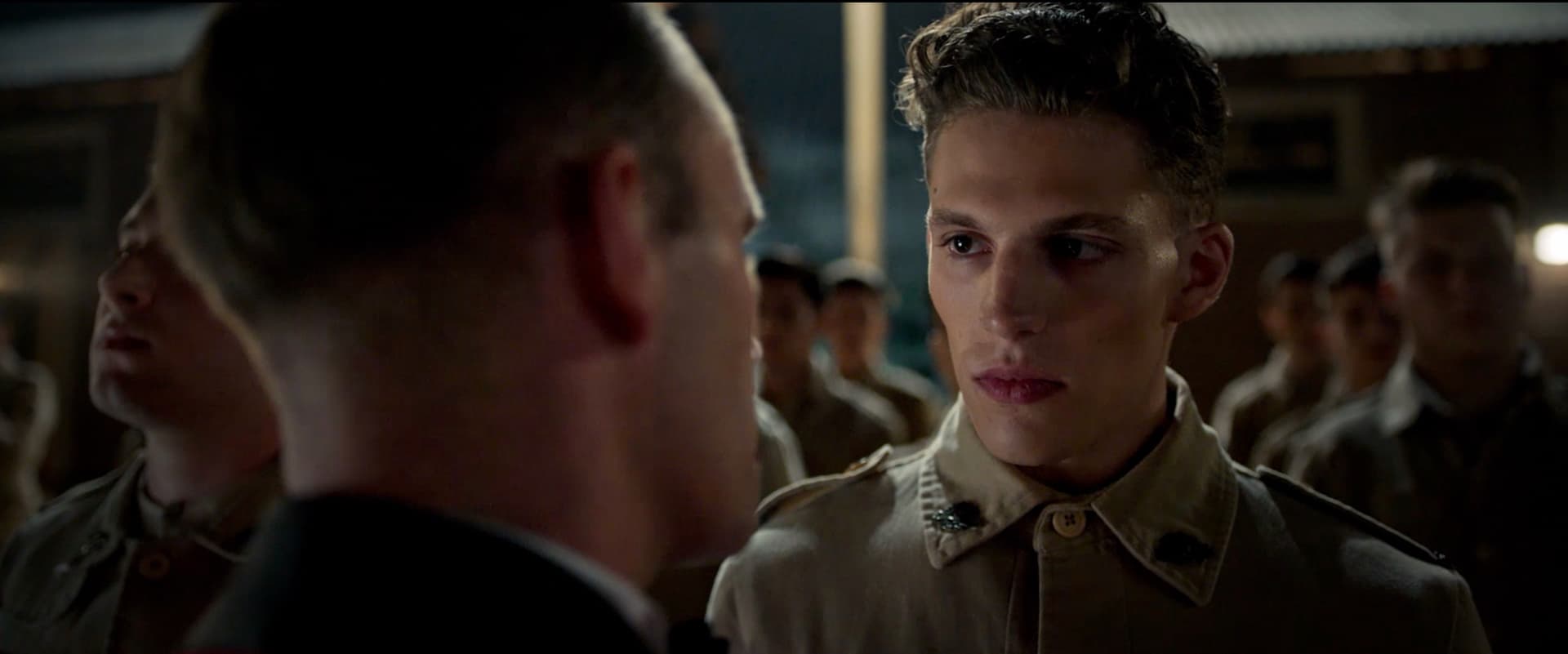 Tristan Alexander in military uniform facing an officer in a dramatic war film scene